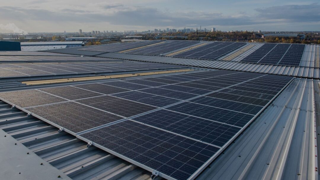 solar panels on a roof with a city skyline