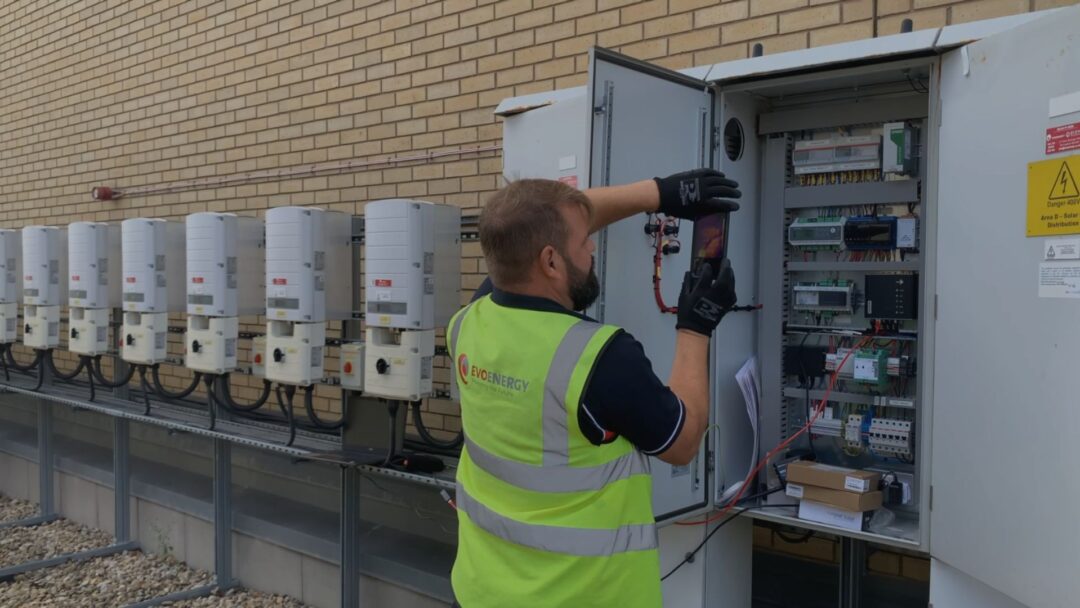 solar maintenance engineer fixing inverters