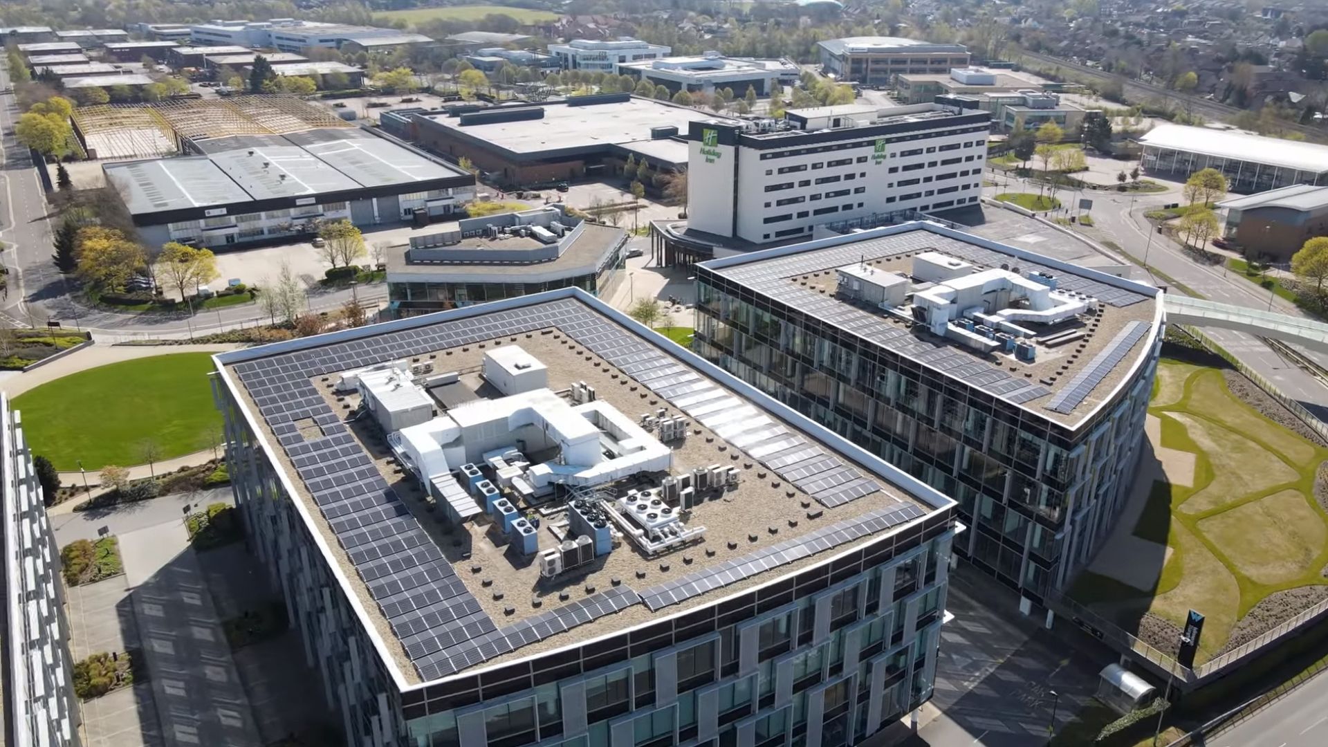 A large array of solar panels installed on a flat roof showcasing clean and renewable energy technology.