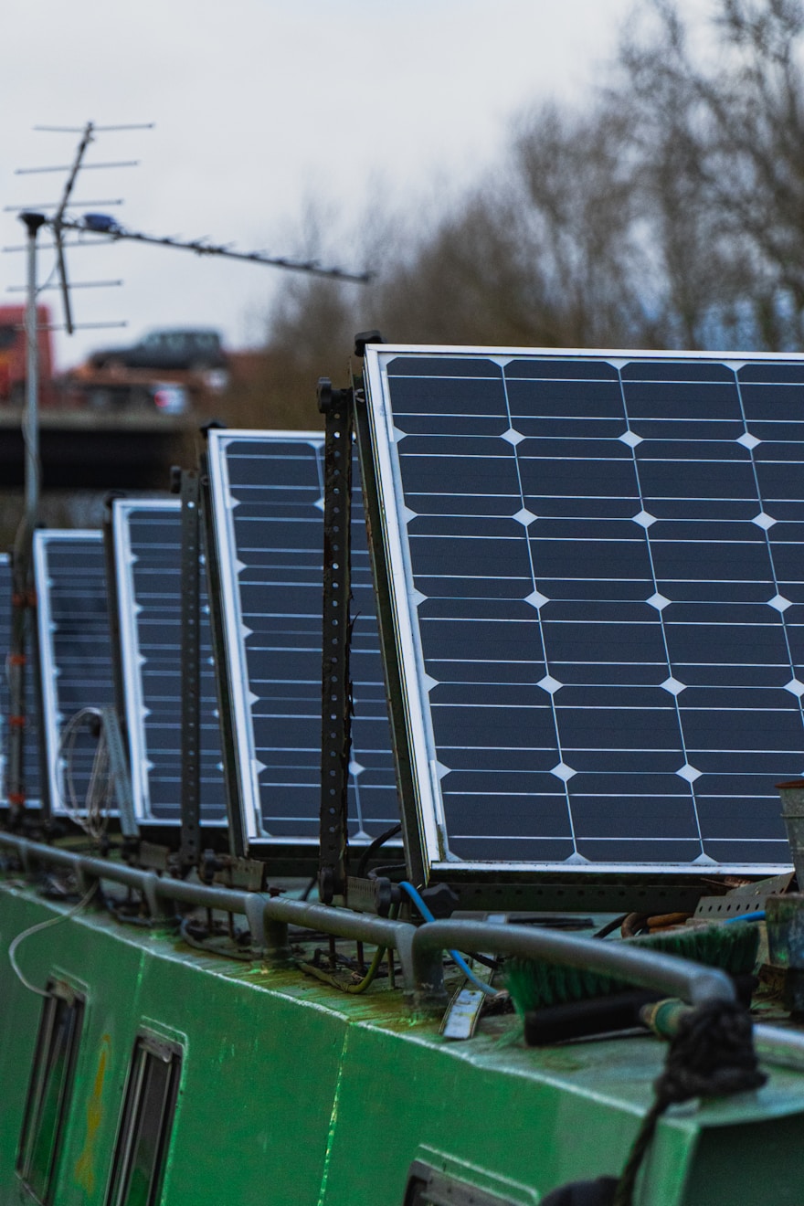 Row of solar panels installed on the roof of a narrowboat, generating renewable energy on a canal boat in Repowering/Upgrade