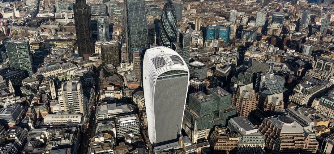 Aerial view of central London featuring the Walkie Talkie building and surrounding skyscrapers in the financial district.