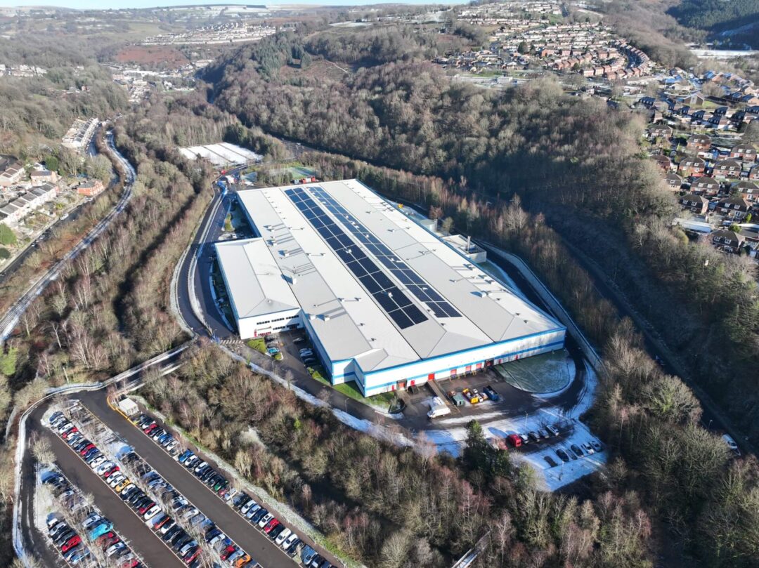Sun-powered transformation atop the manufacturing warehouse: solar panels in action.