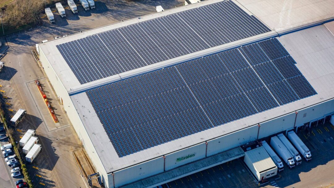 solar panels on top of a building next to lorries