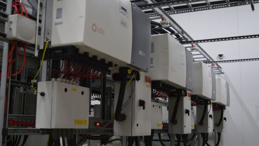 Indoor solar PV inverter room featuring multiple Solis string inverters and connected control boxes, part of a commercial renewable energy system in Cranswick Eye
