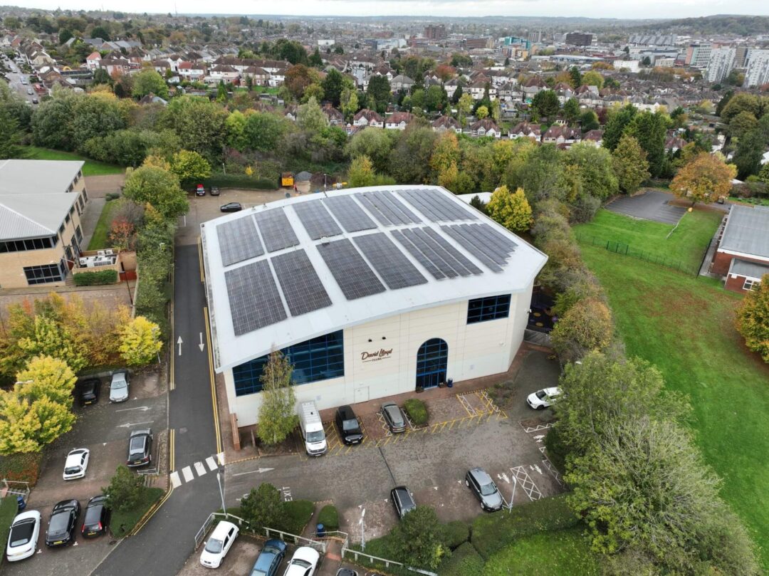 Radiant sustainability Curved gymnasium roof adorned with cutting-edge solar panels.