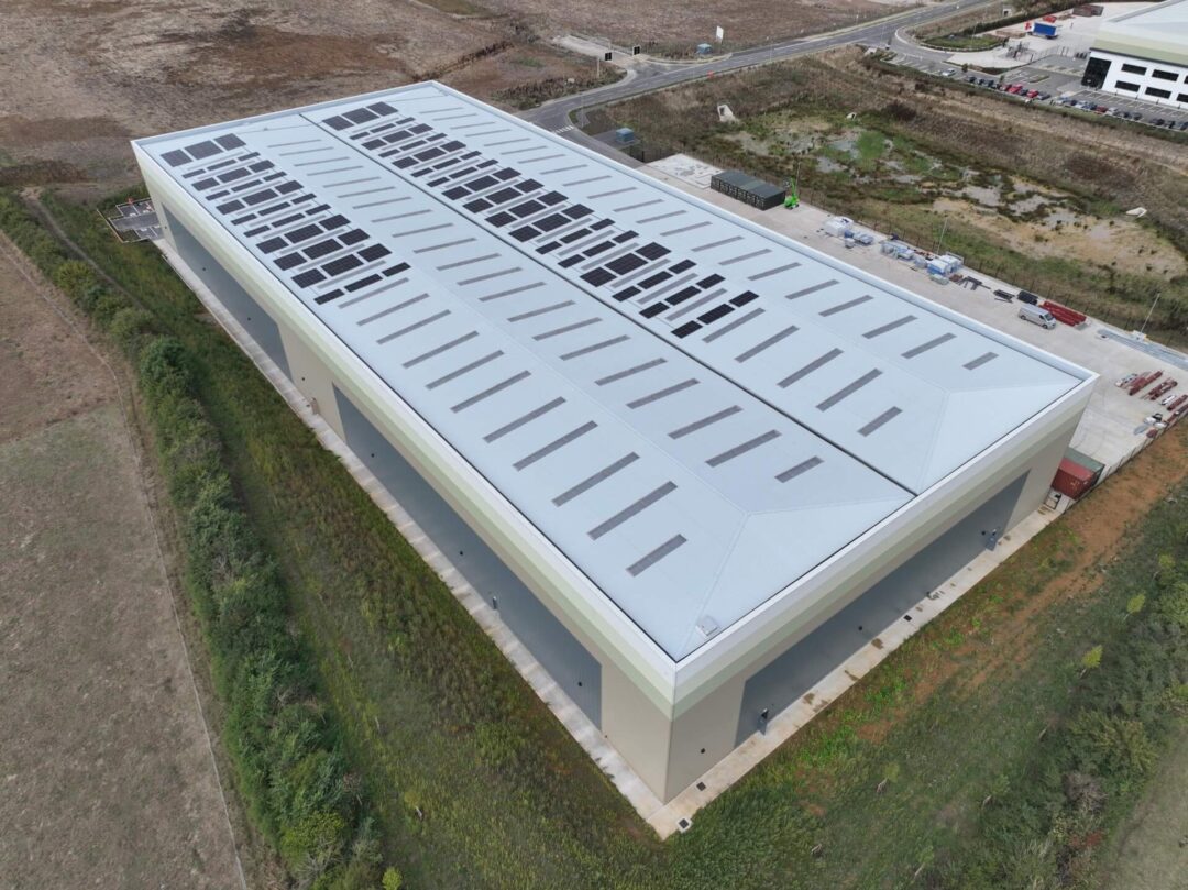 Half of warehouse roof adorned with solar panels