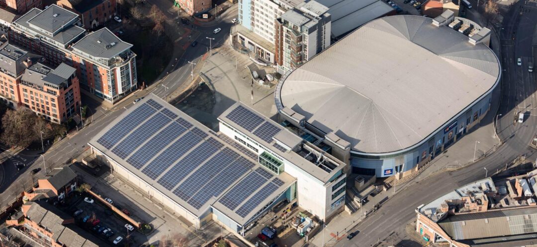 solar panels on roof next to sports arena