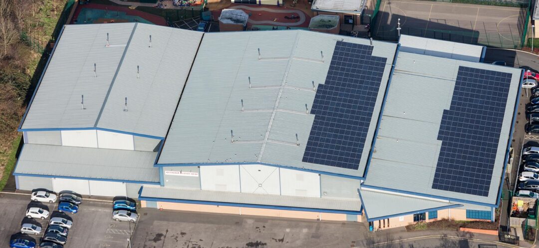 Solar panels spanning multiple buildings in an array.