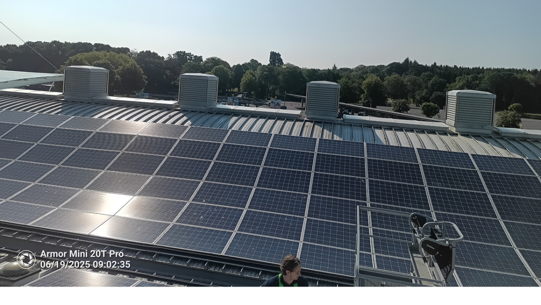 Commercial rooftop solar PV installation at Paultons Park with multiple panel arrays on an industrial building roof