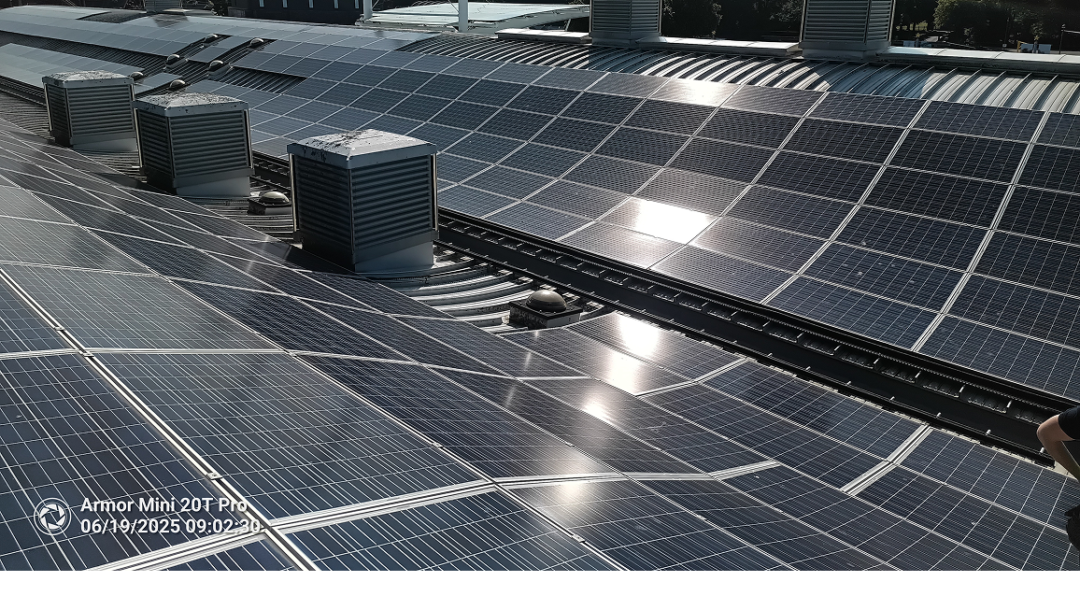 Rooftop solar panels installed around HVAC units on a commercial building, optimised for space and energy generation