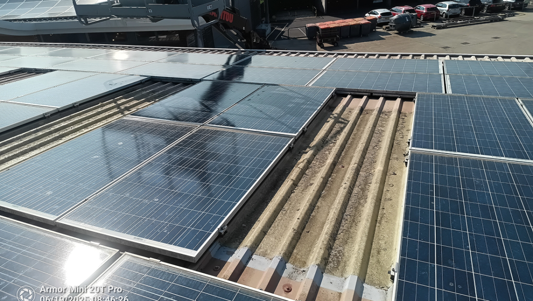 Commercial rooftop solar PV installation at Paultons Park with multiple panel arrays on an industrial building roof